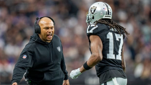 Raiders interim head coach Antonio Pierce (left) high-fives wide receiver Davante Adams (17) after a touchdown against the Giants during the first quarter at Allegiant Stadium.